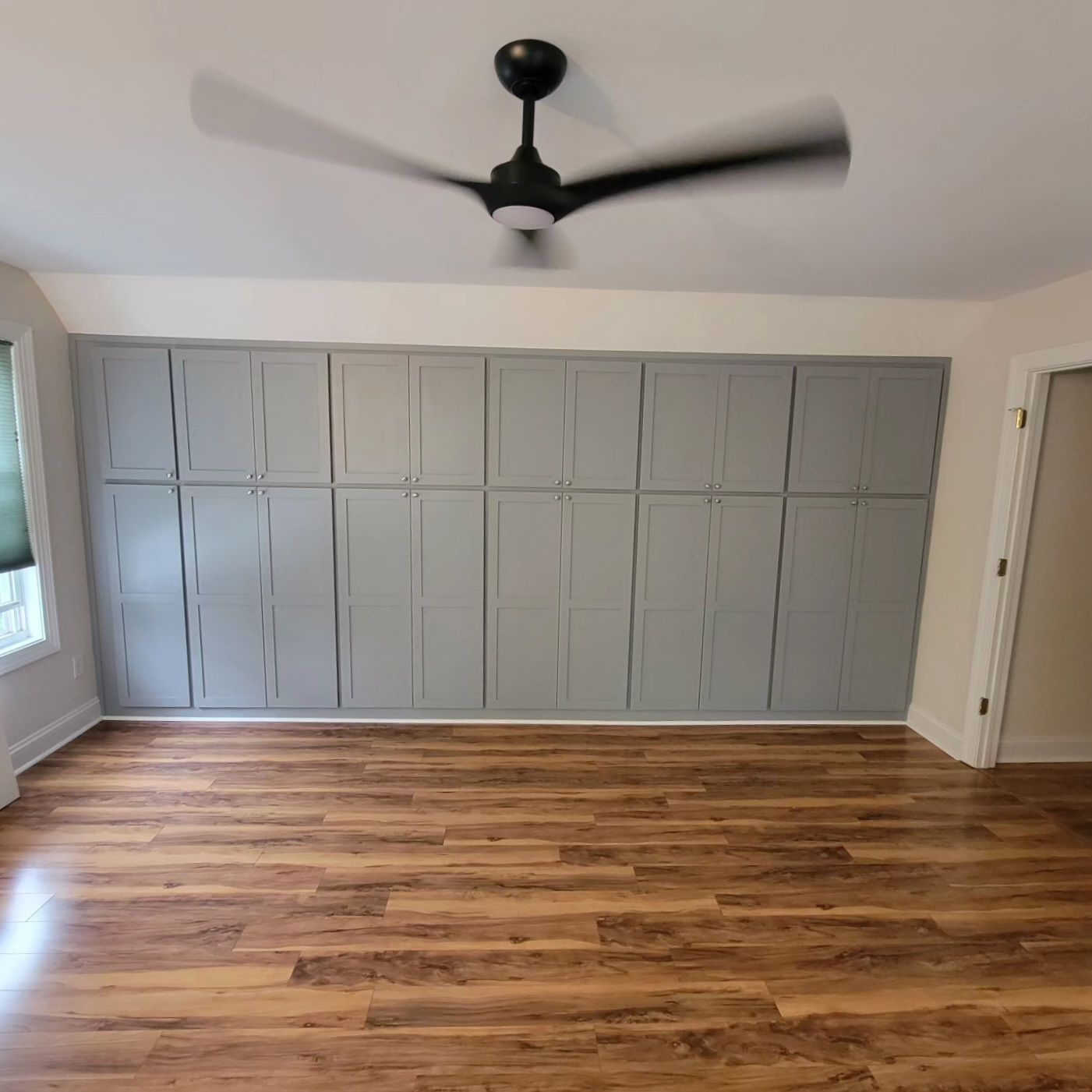 There is a ceiling fan in the corner of the room.