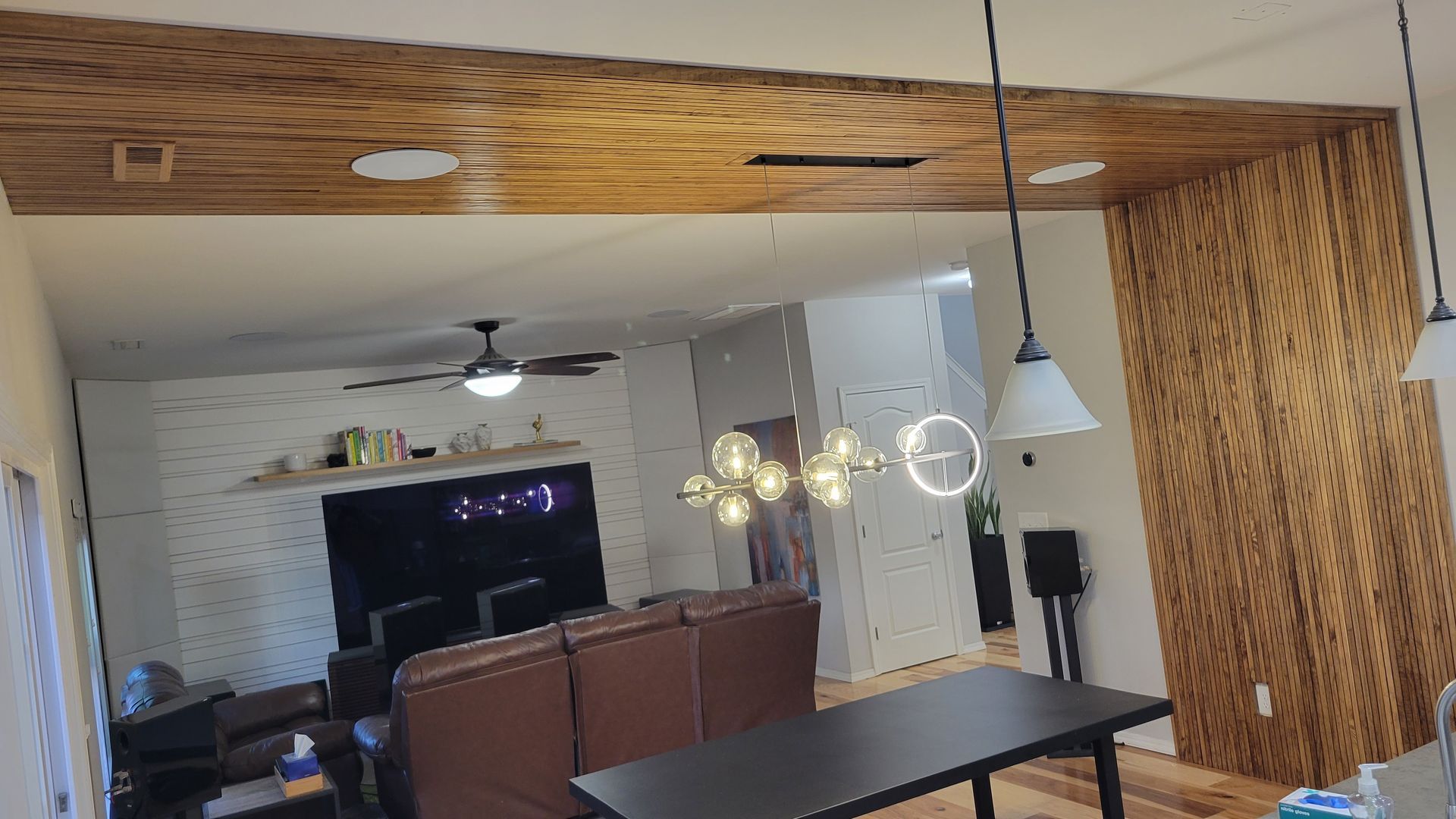 A living room with a couch , table , and ceiling fan.