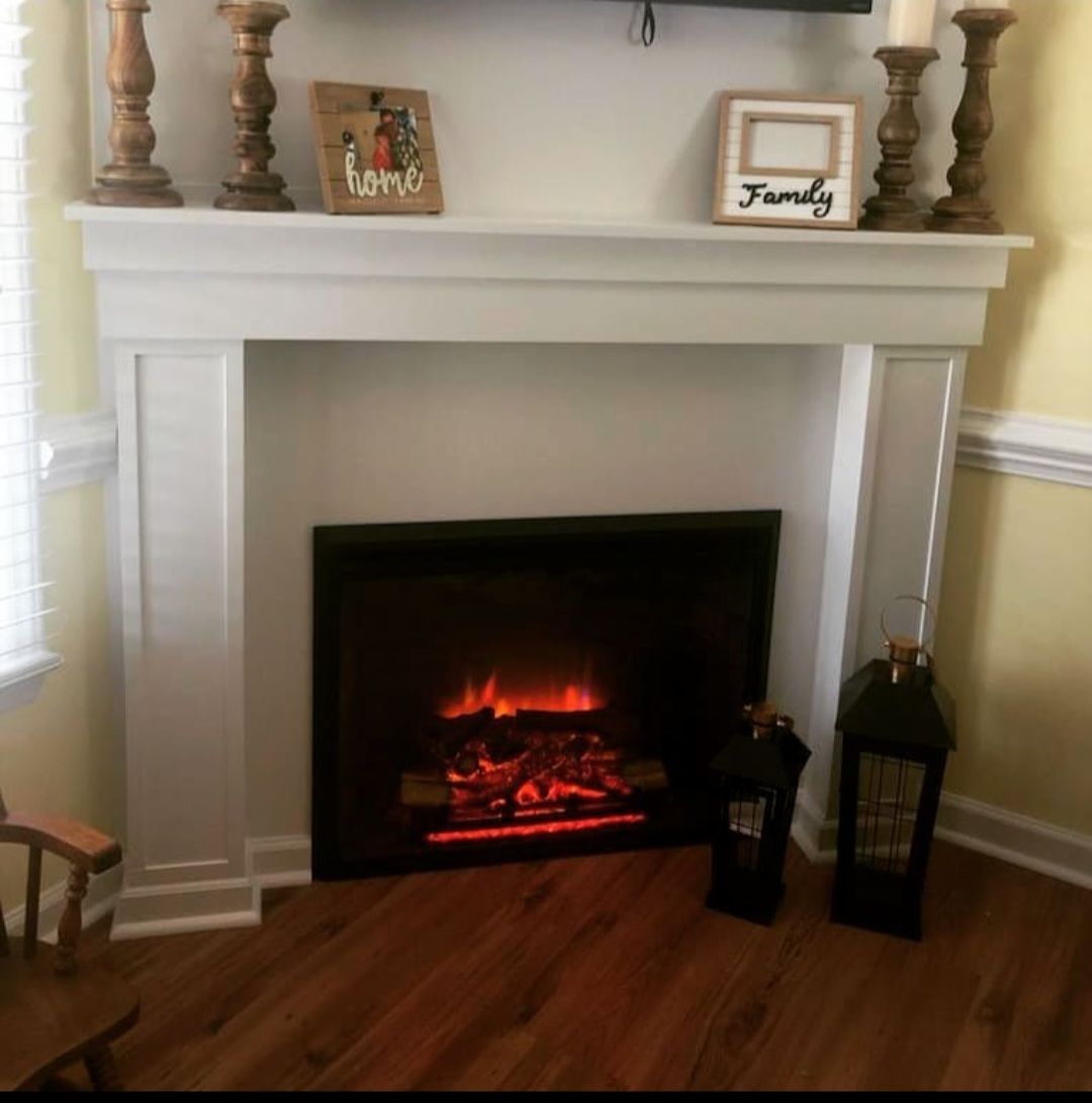 A living room with a fireplace and a sign that says family