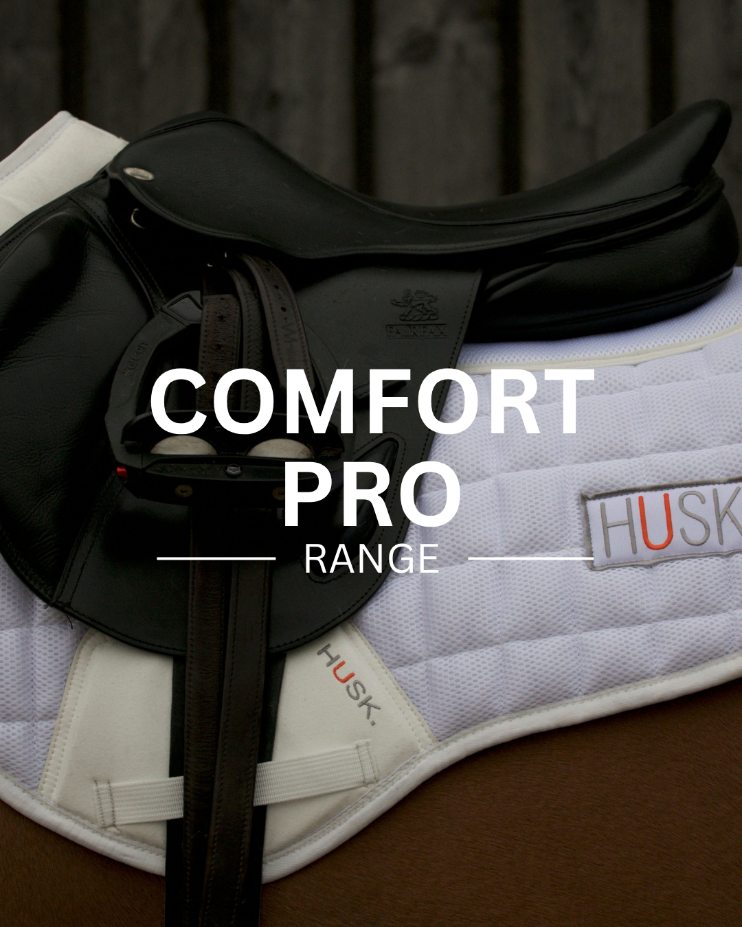 Black riding saddle on a white quilted saddle pad, text: Comfort Pro Range.