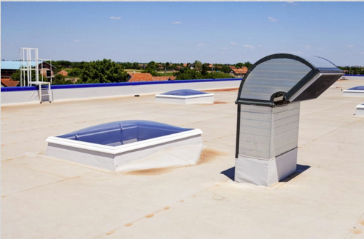 A roof with two skylights and a chimney on it