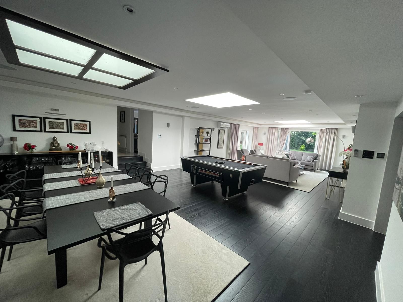 There is a pool table in the middle of the room.