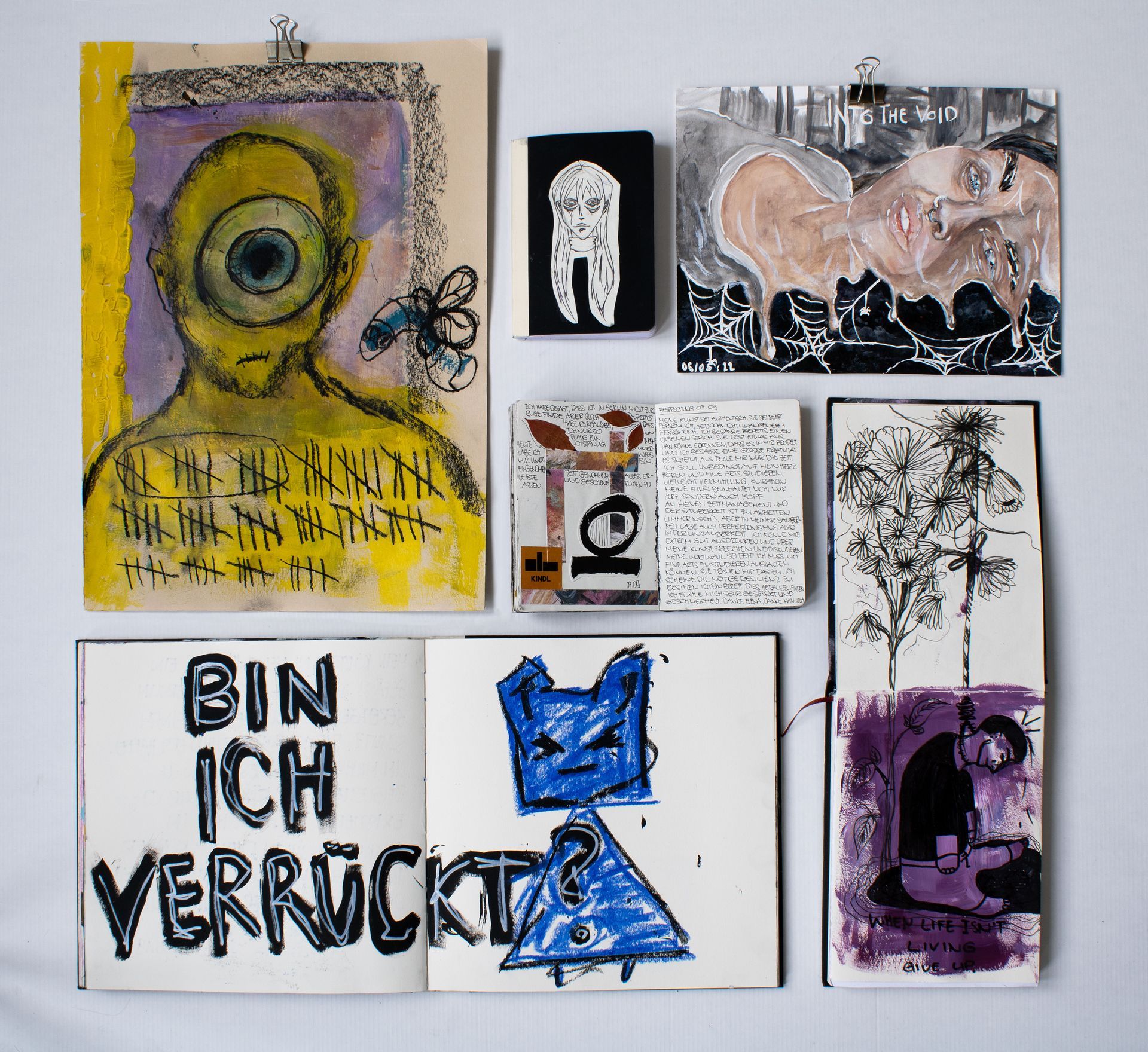 Photograph of various sketchbooks.