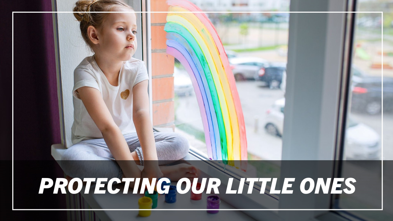 Young girl in a ballet outfit sitting on a windowsill looking outside.