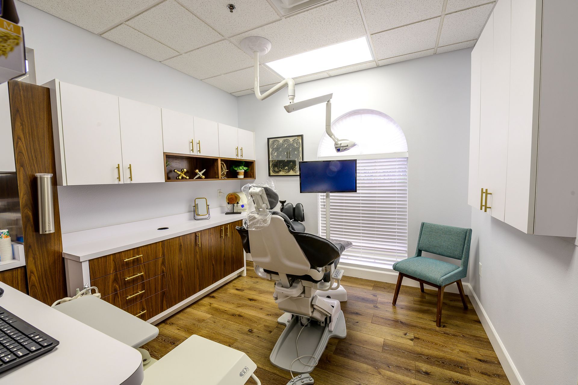 A dental office with a dental chair and a chair.