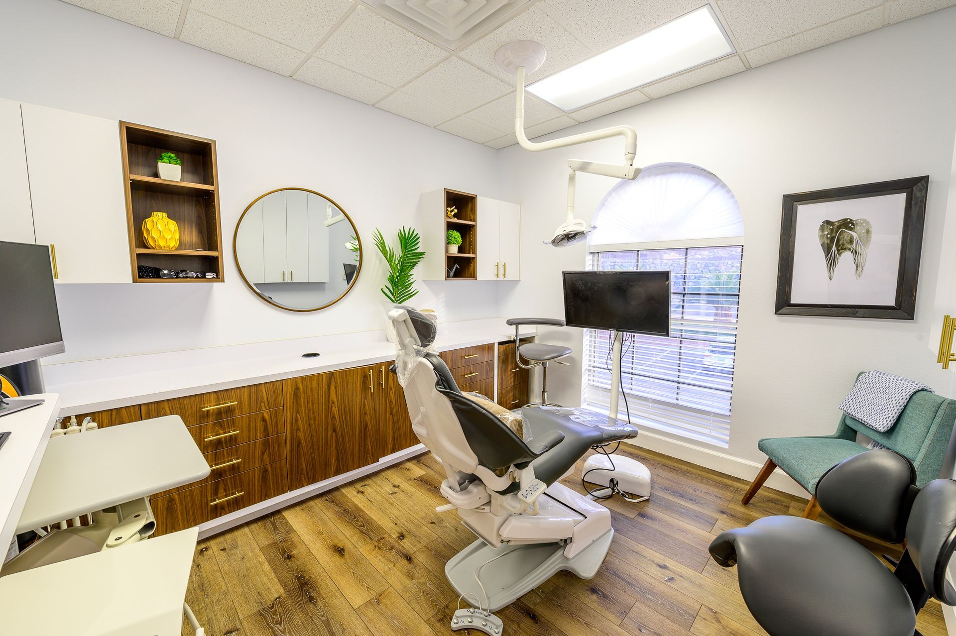A dental office with a dental chair and a television.