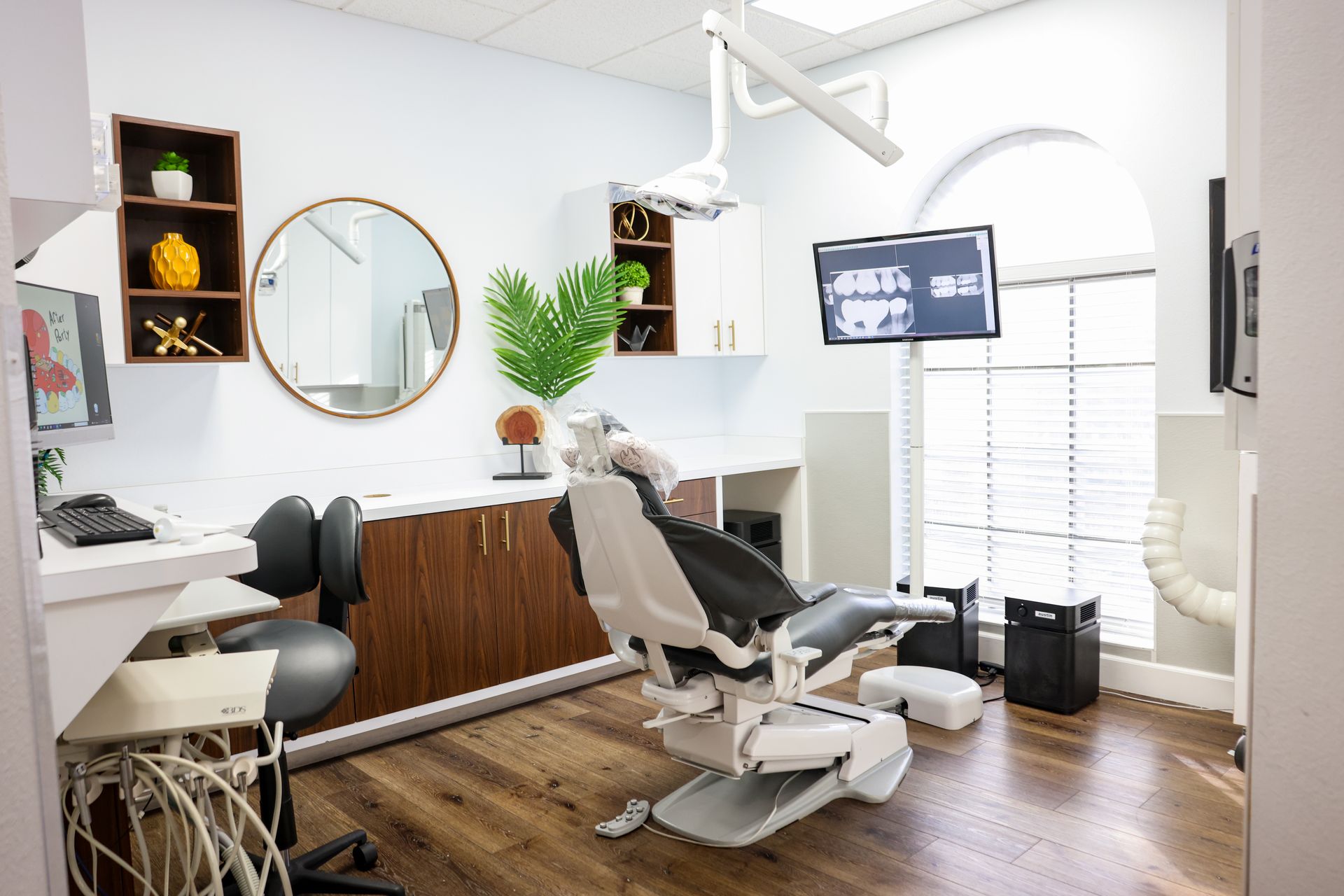 A dental office with a dental chair and a television.
