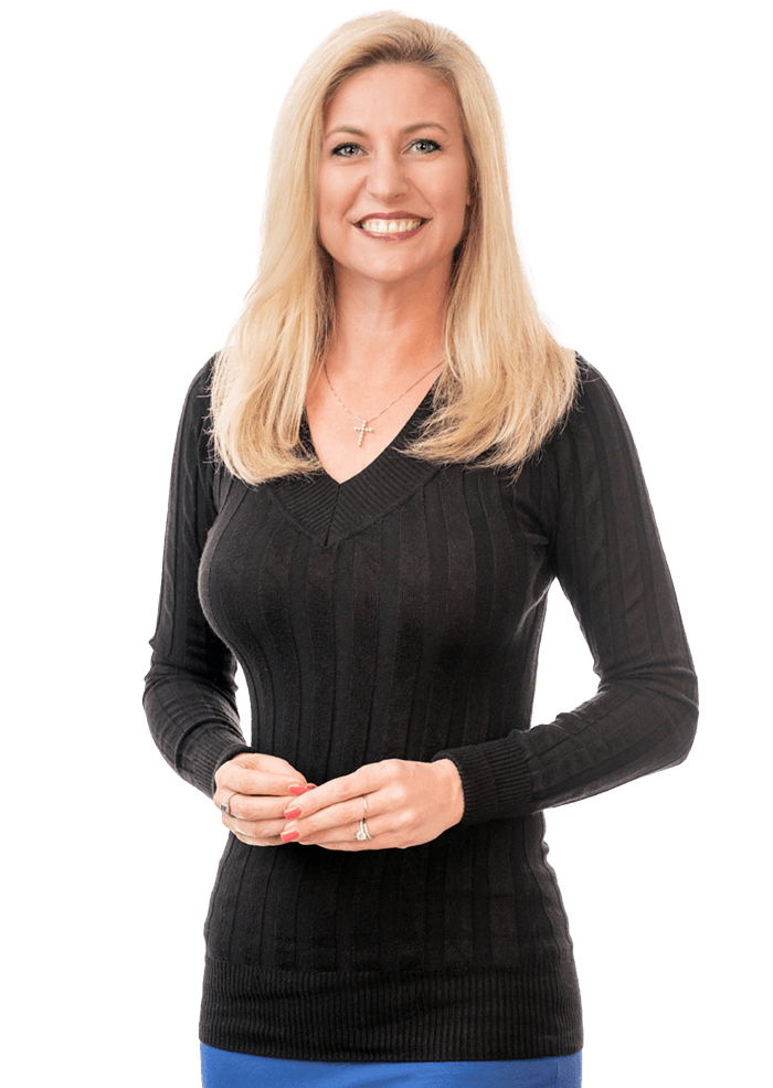 Blonde woman smiling, wearing a black sweater, hands clasped, against a white background.