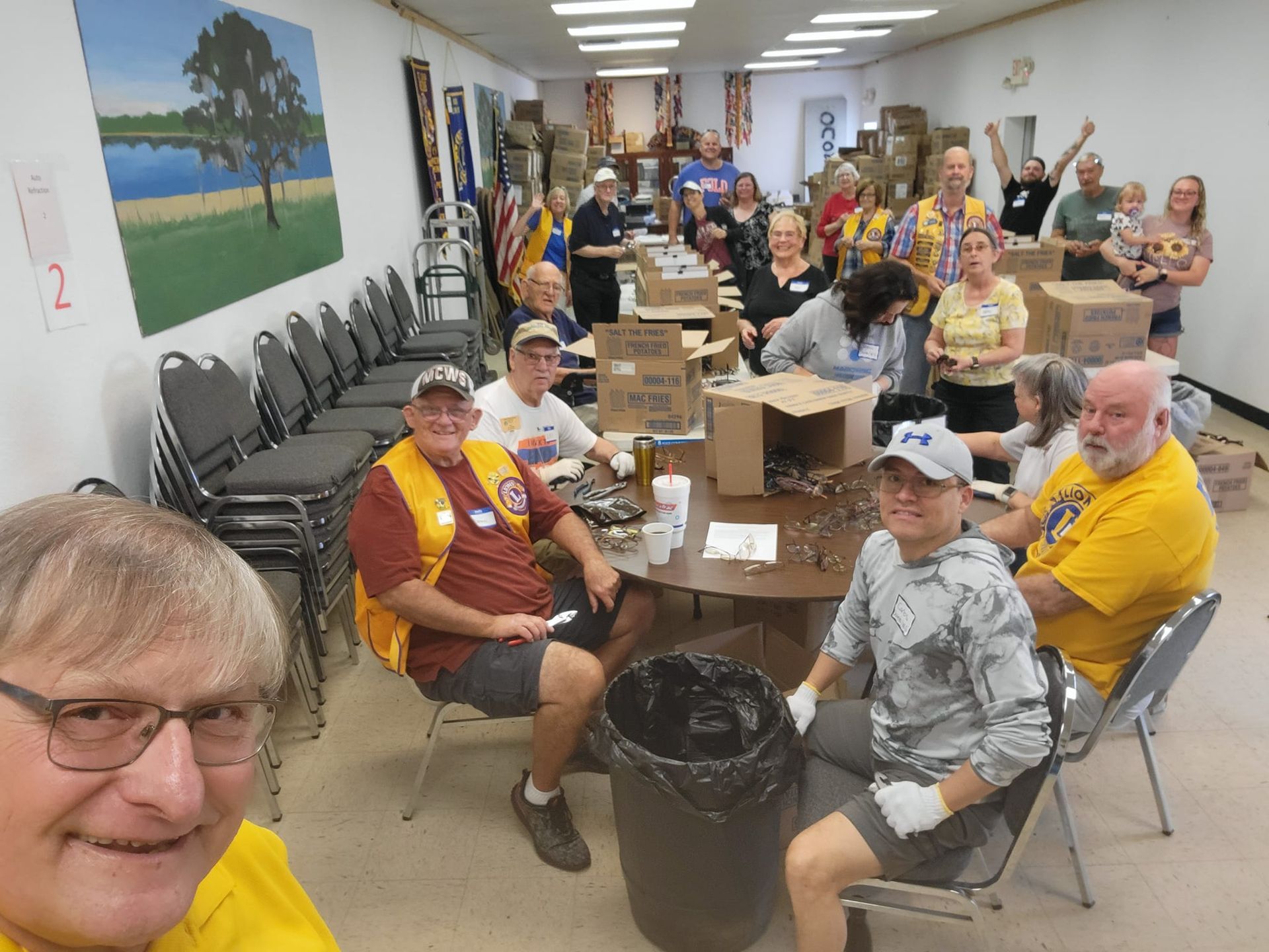 A group of people are sitting around a table in a room.