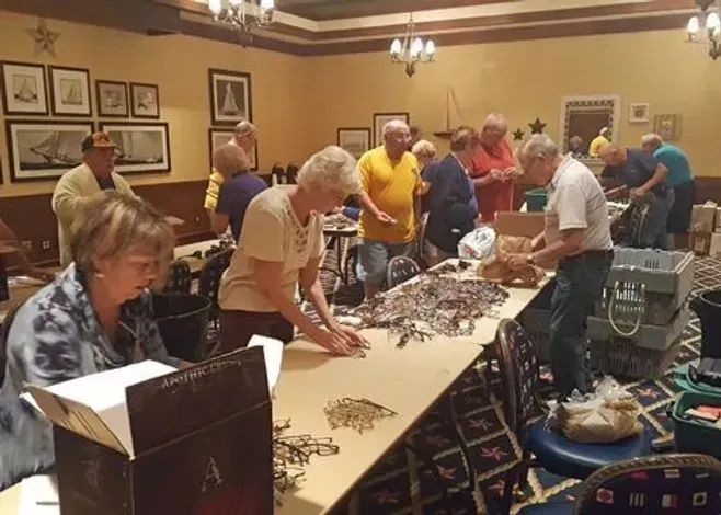 A group of people are gathered around a table in a room