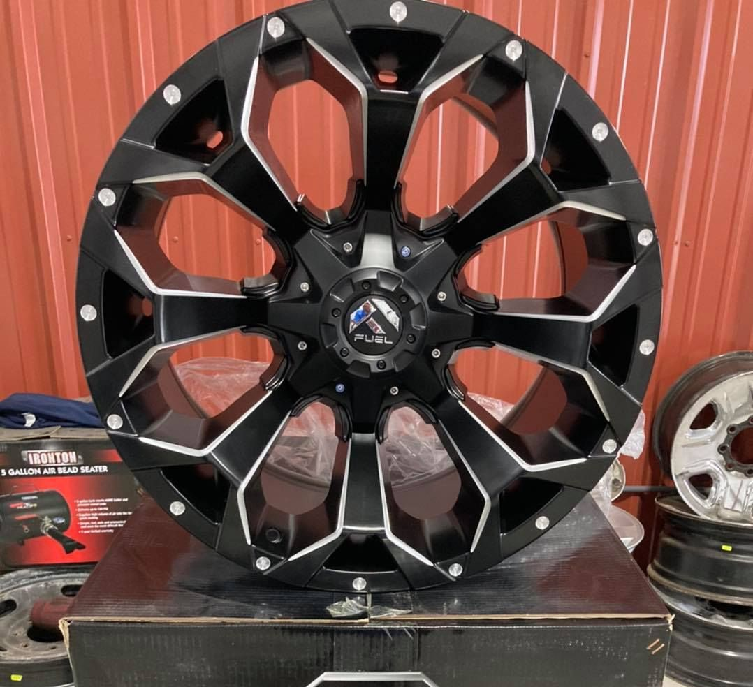 A man is installing an air conditioner on the side of a building.