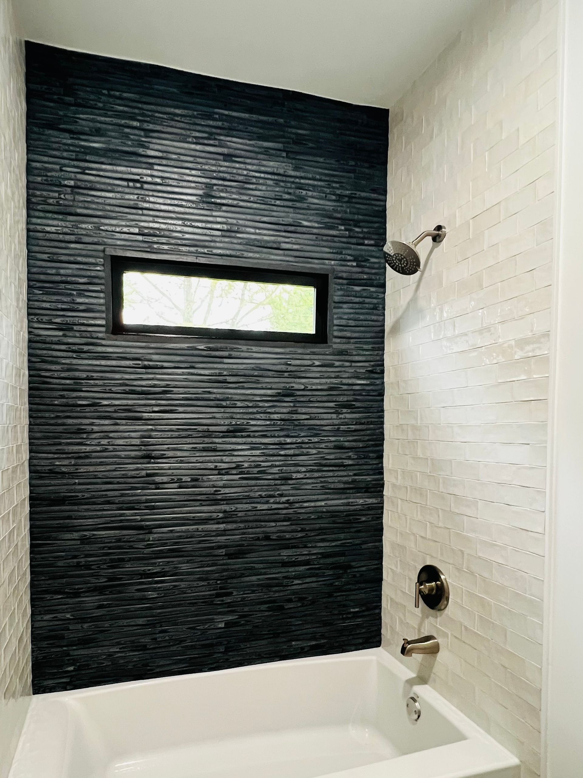 A bathroom with a bathtub and a shower.