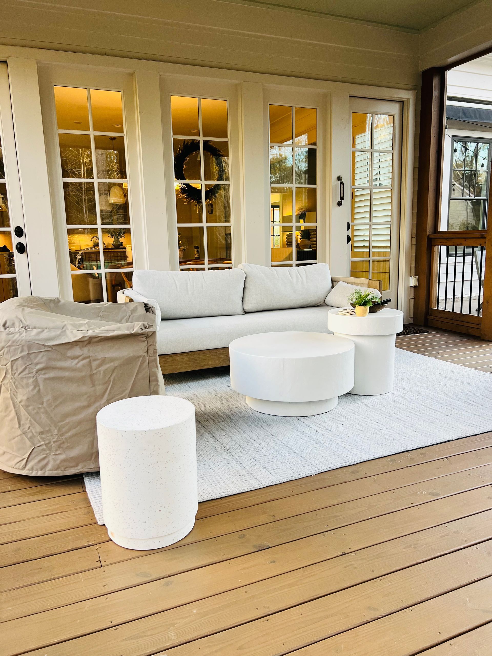 A living room with a couch , table and chairs