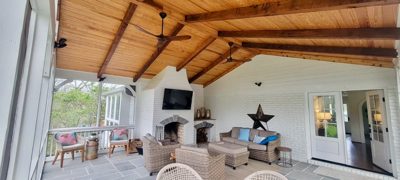 A living room with a couch , chairs , and a fireplace.