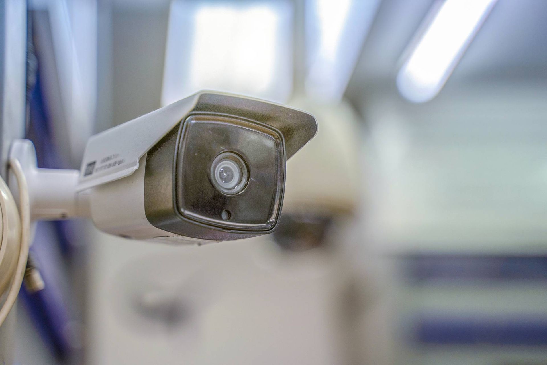 A security camera is hanging on a wall in a room