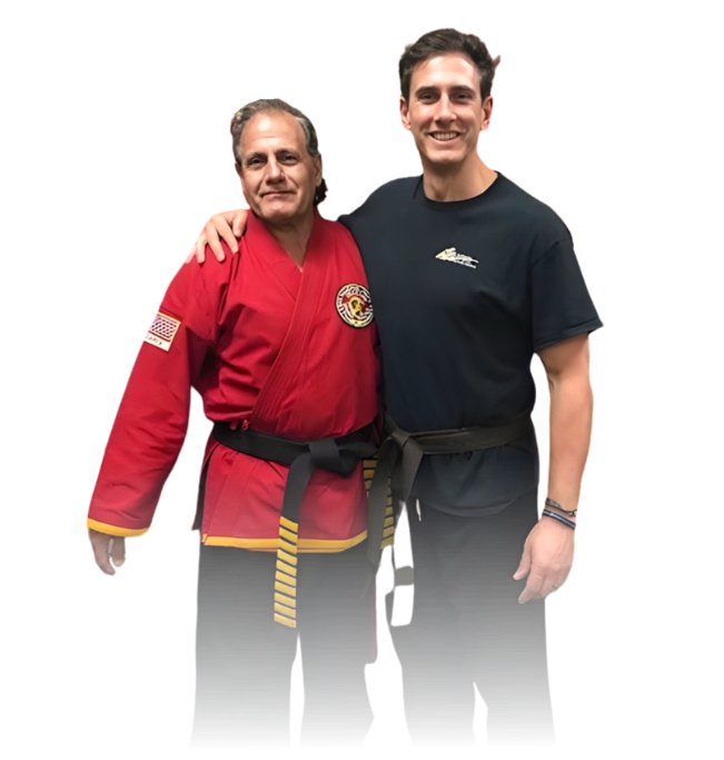 Man pointing, smiling, wearing black hoodie; arm tattoo visible.