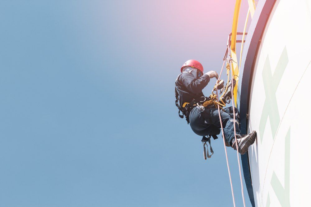 A Man is Climbing Up the Side — EDU-BABA Pressure Cleaning in Evatt, ACT