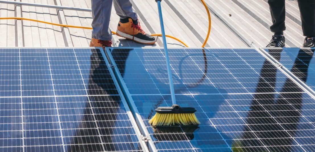 A Person is Cleaning a Solar Panel With This Broom — EDU-BABA Pressure Cleaning in Gungahlin, ACT