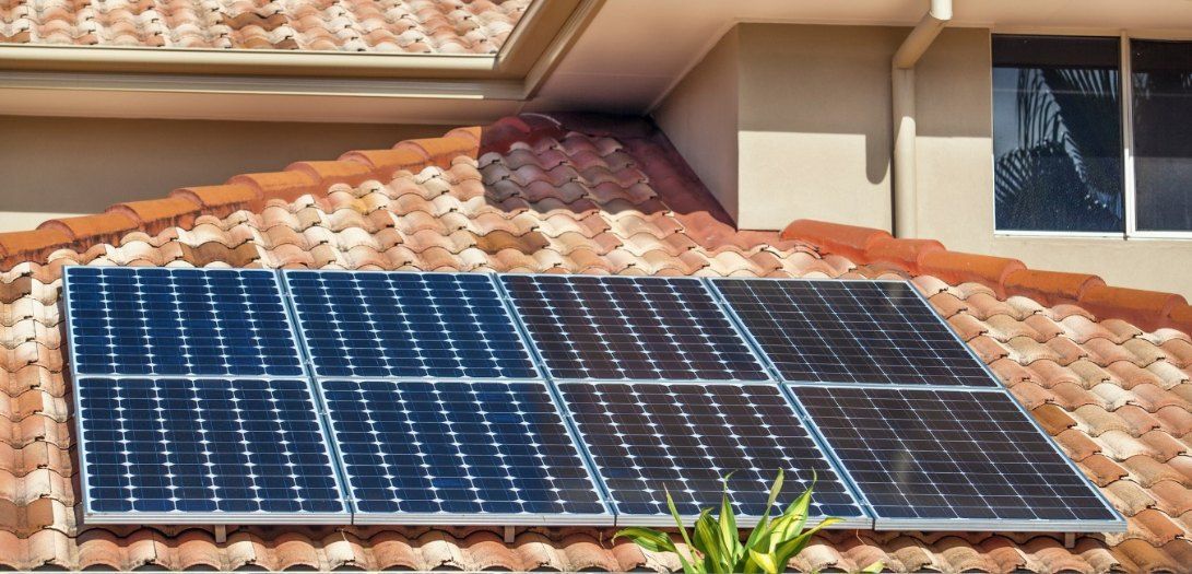 A Row of Solar Panels on the Roof of a House — EDU-BABA Pressure Cleaning in Weston Creek, ACT