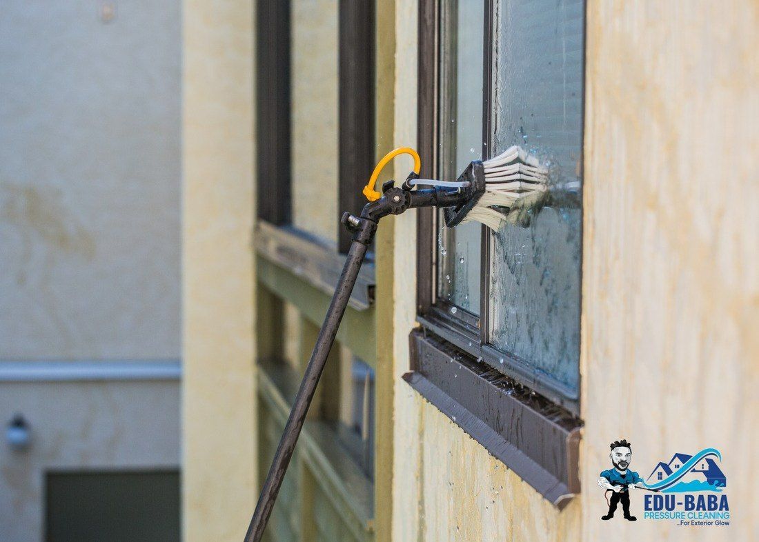 A Person is Cleaning a Window With This Mop — EDU-BABA Pressure Cleaning in Belconnen, ACT