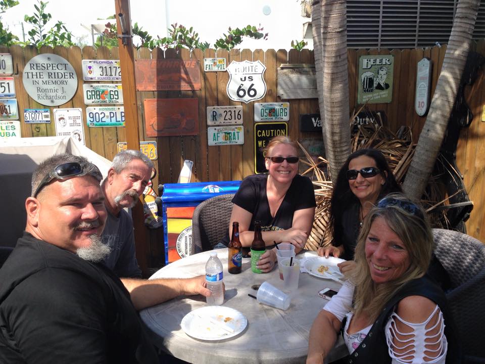 A group of people sitting around a table with a sign that says route 66 on it