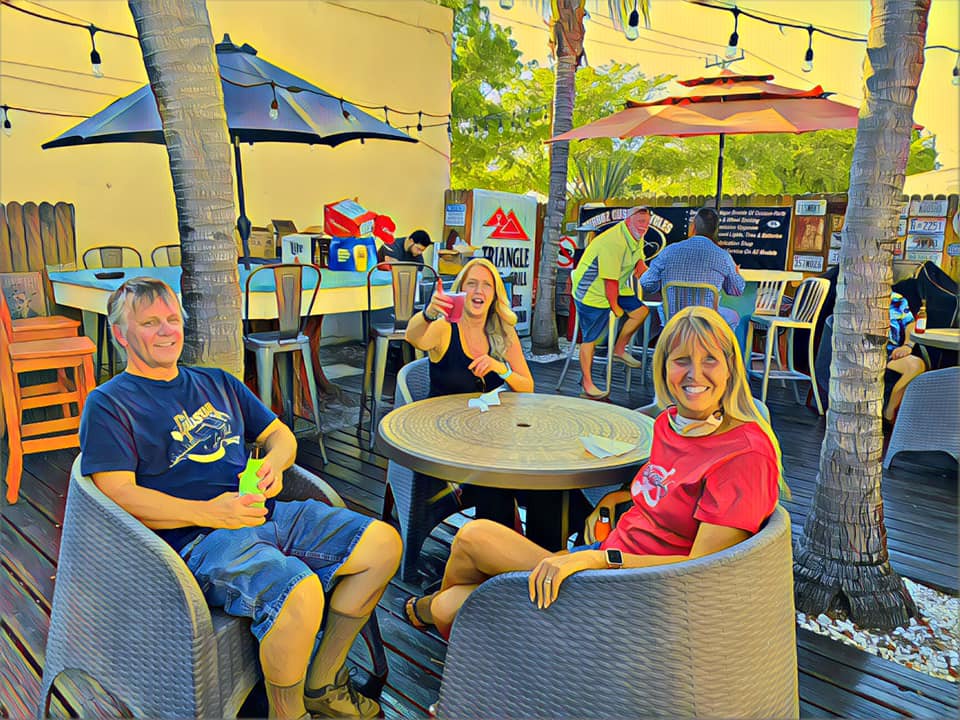 A man and a woman are sitting at a table outside