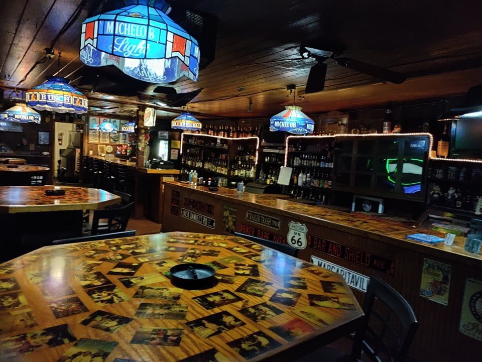 A restaurant with tables and chairs and a sign that says rancho