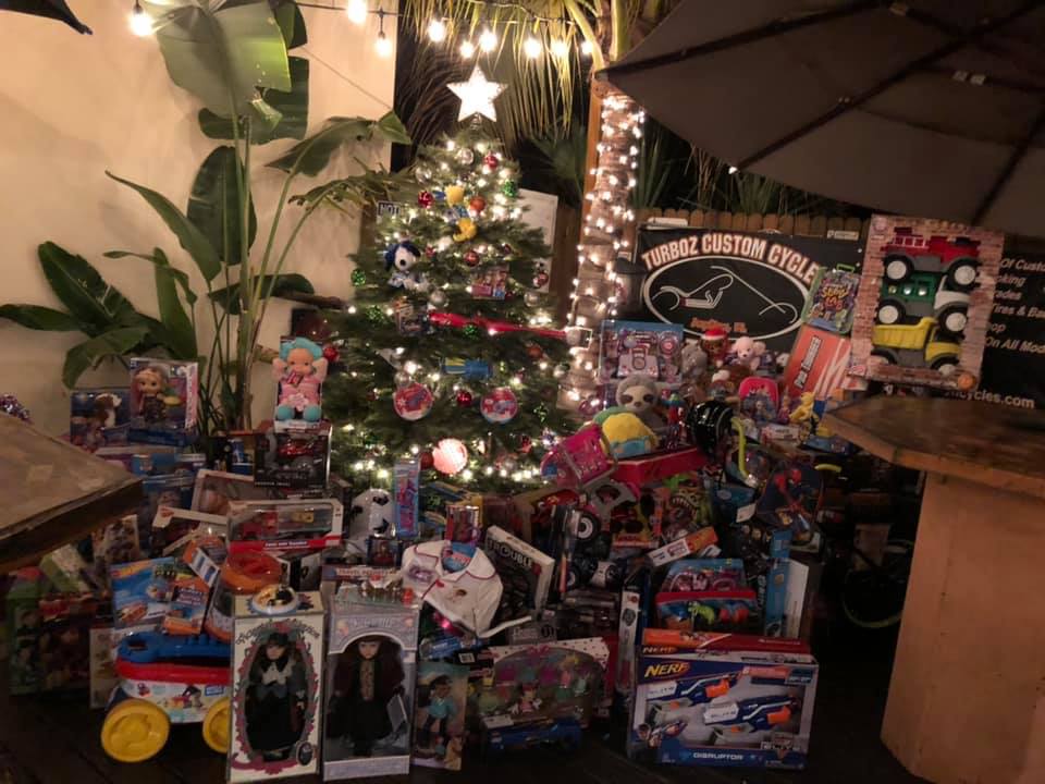 A christmas tree is surrounded by lots of toys