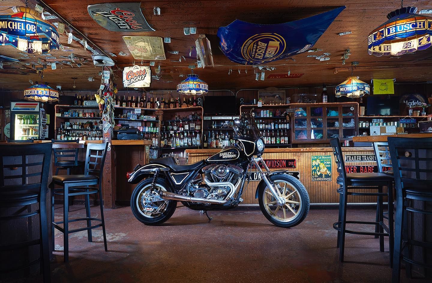 A motorcycle is parked in the middle of a bar