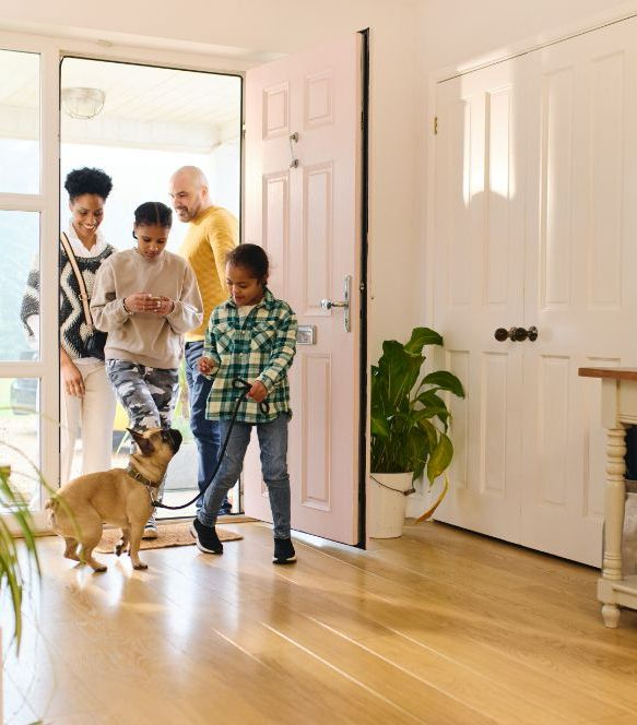 A Family And Their Dog Are Walking Into A House — One Lane Financial In Burdell, QLD