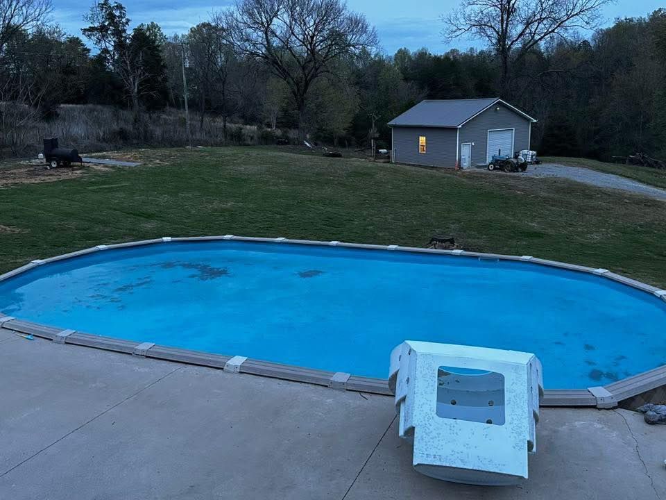 A large swimming pool with a shed in the background
