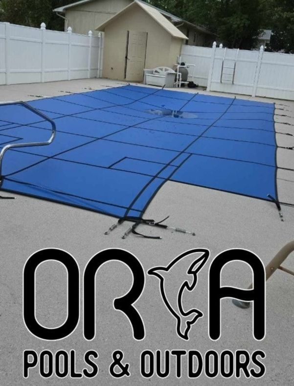 A blue pool cover on a pool.