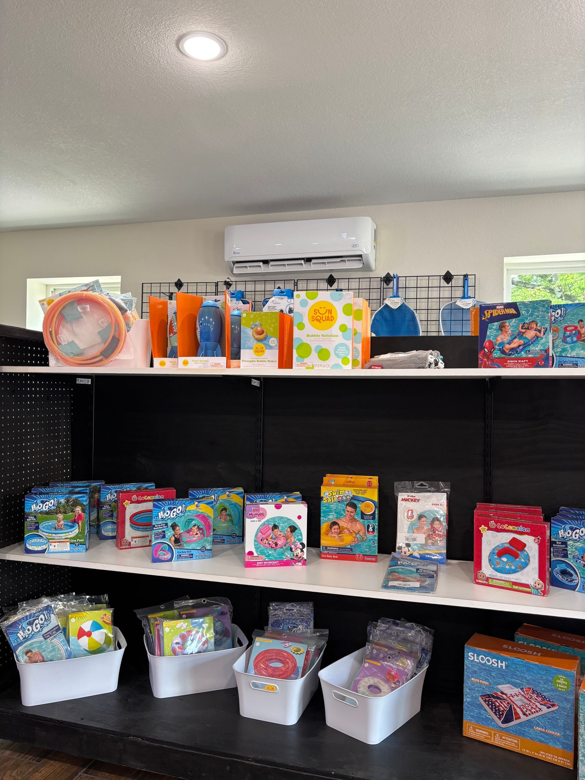 A shelf filled with lots of toys in a store.