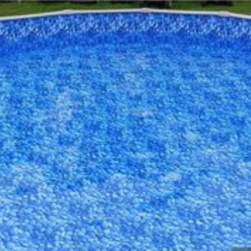 A large swimming pool filled with blue water.