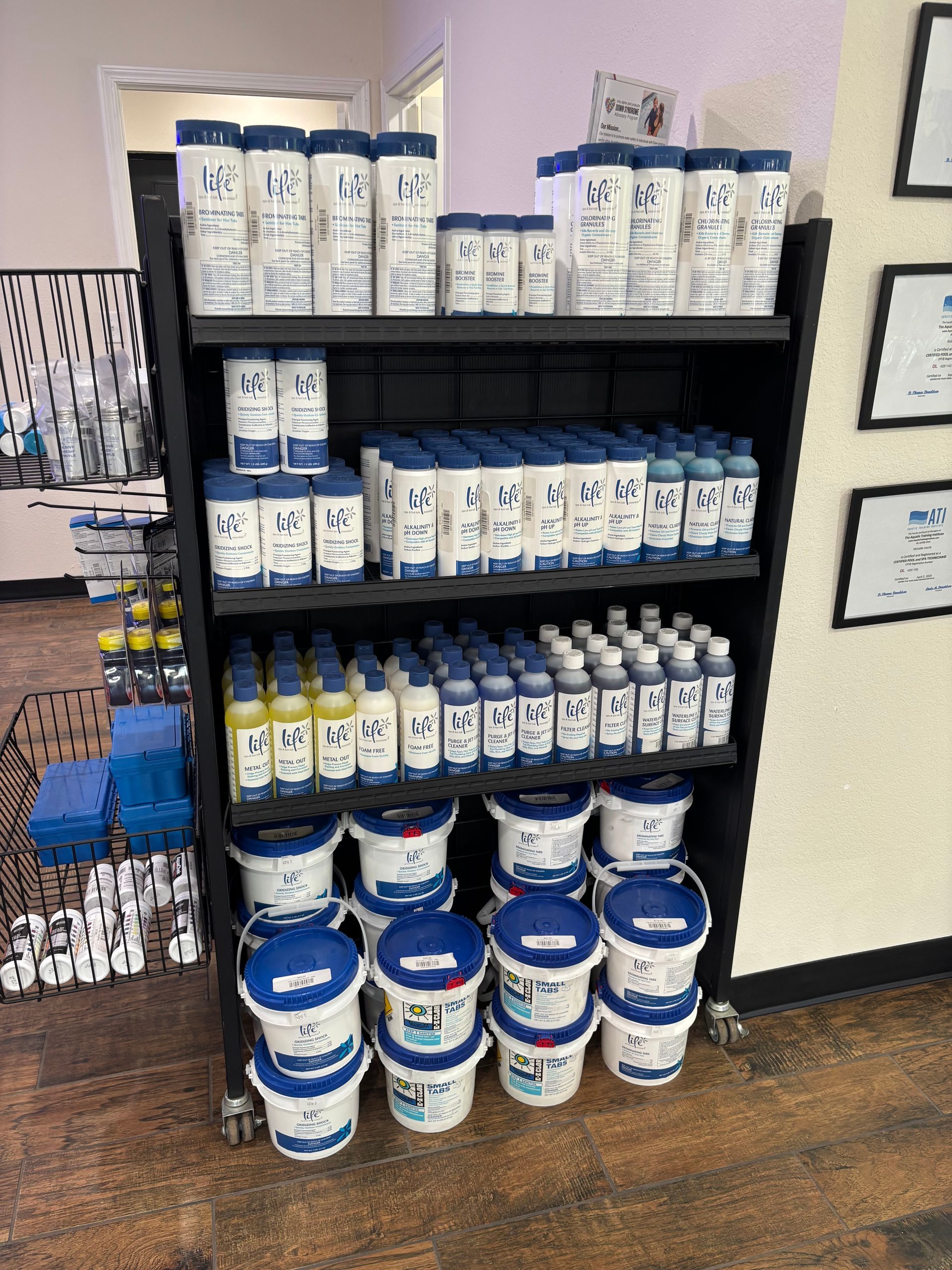 A shelf filled with buckets and bottles of cleaning supplies.