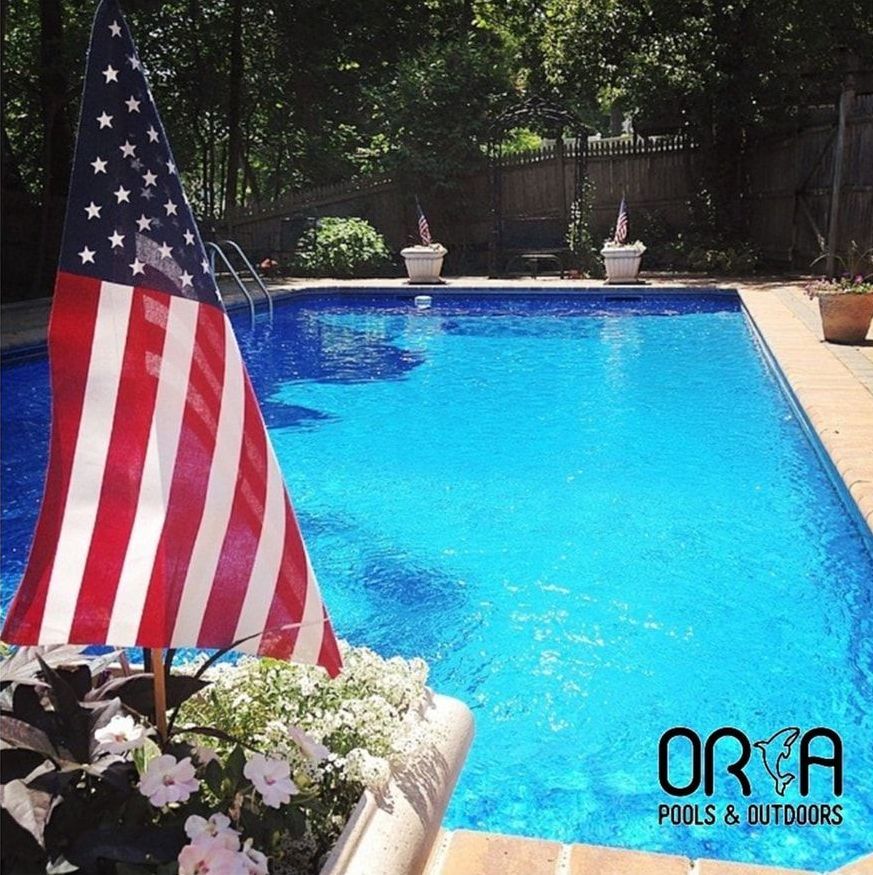 A swimming pool sponsored by ORCA Pools and Outdoors.