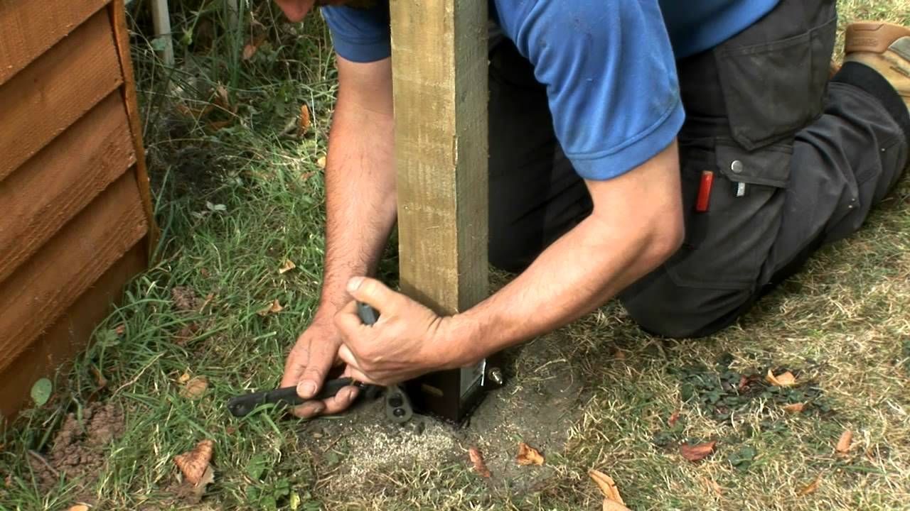 Damaged wooden garden fence being repaired by a garden handyman in Kingston