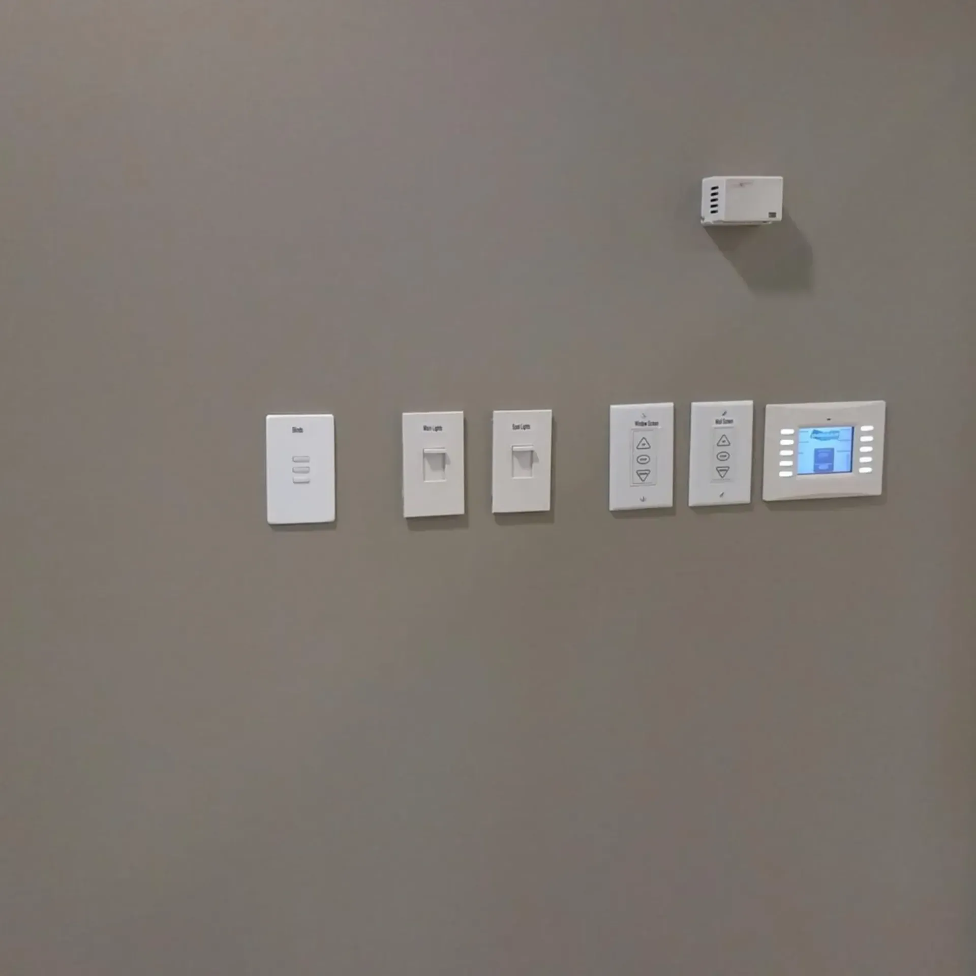 Wall with several electrical switches and a smart home control panel