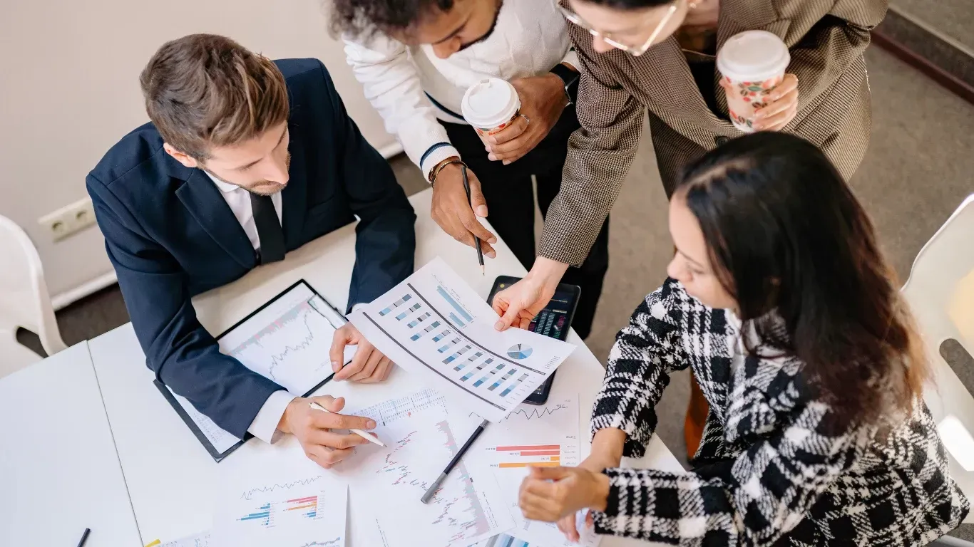 Business owner reviewing improved performance analysis results and upward financial trends with KPI Solutions Chelmsford MA