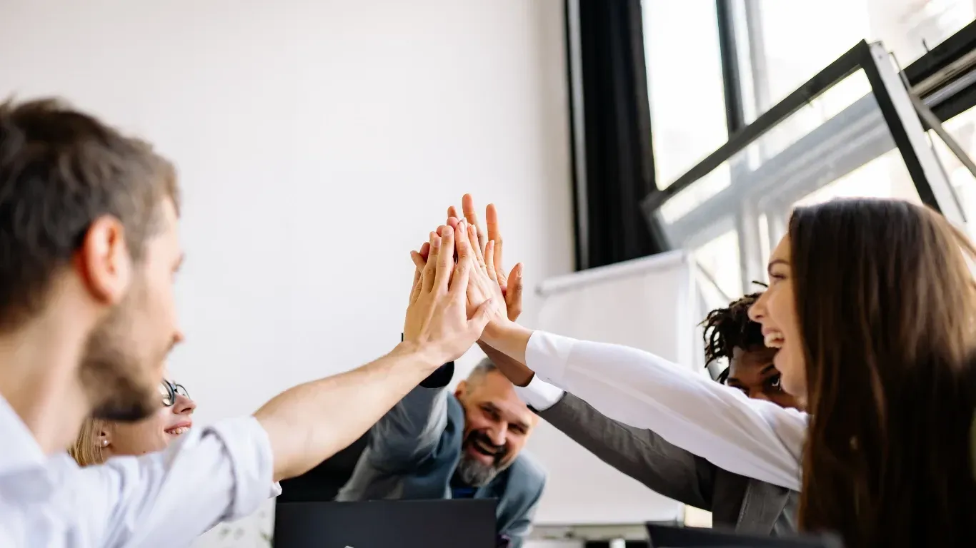 Small business owner celebrating success and growth after partnering with KPI Solutions business advisory in Chelmsford MA