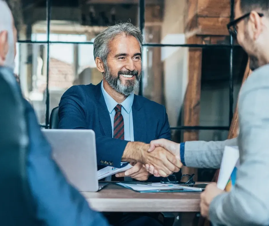 Business owner and KPI Solutions bookkeeping advisor handshake partnership financial clarity Chelmsford Massachusetts