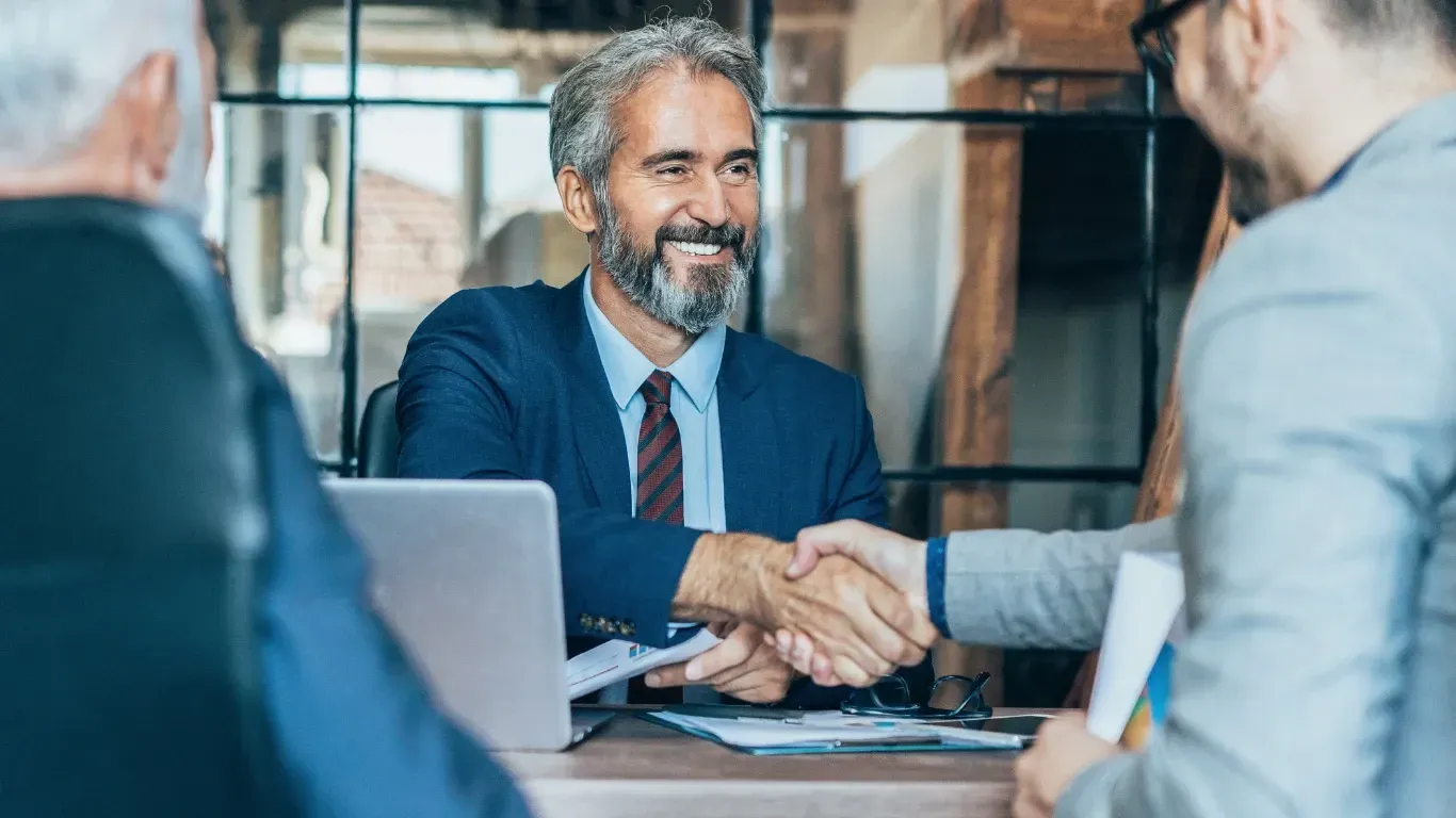 Business owner and KPI Solutions bookkeeping advisor handshake partnership financial clarity Chelmsford Massachusetts