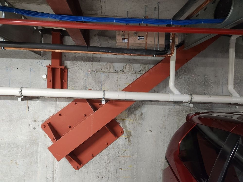 A man is cleaning a shelf in an office.