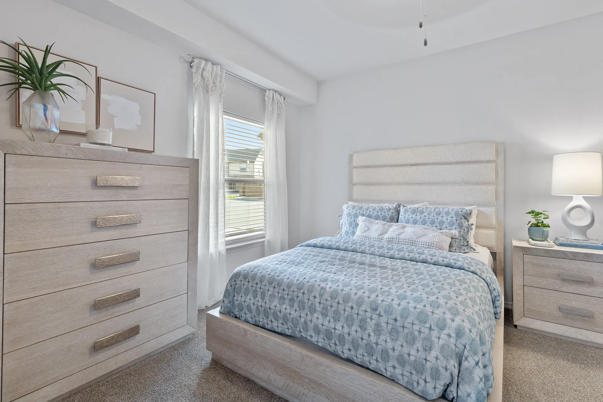 Cozy bedroom featuring a bed, nightstand, and dresser.