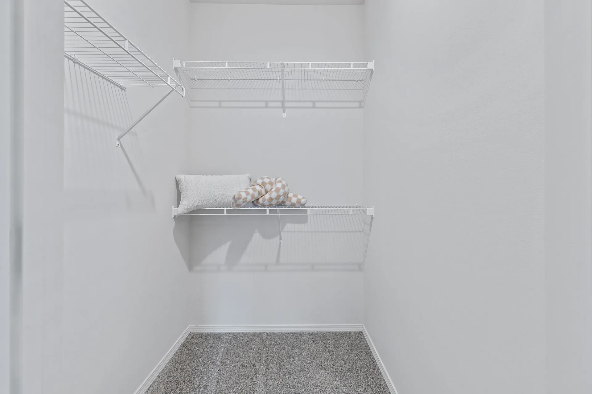 Interior view of a closet with shelving and a cushion