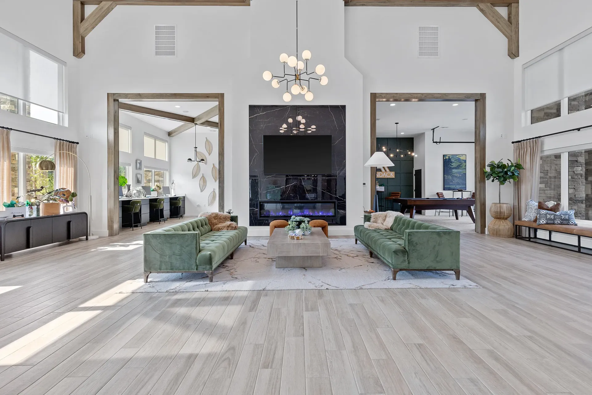 Spacious lounge area with green sofas and modern decor