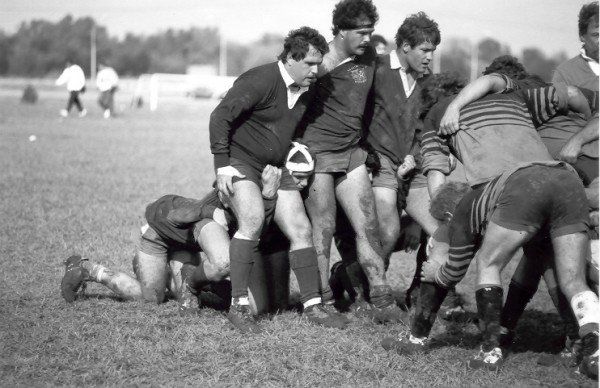A black and white photo of a group of men playing rugby
