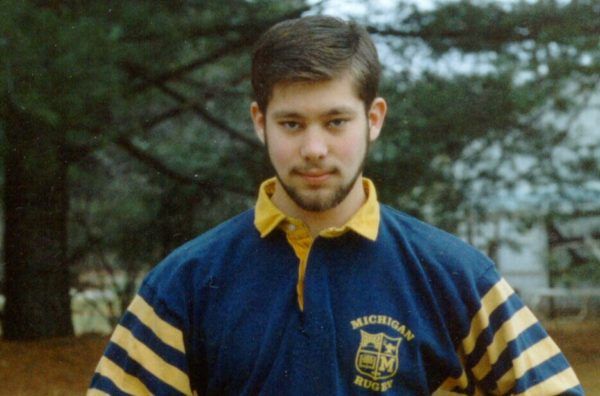 A man wearing a blue and yellow michigan shirt