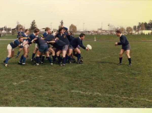 A group of people are playing rugby on a field
