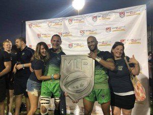 A group of people are posing for a picture while holding a trophy.